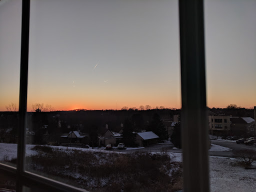 A serene winter sunset over a quiet rural landscape.