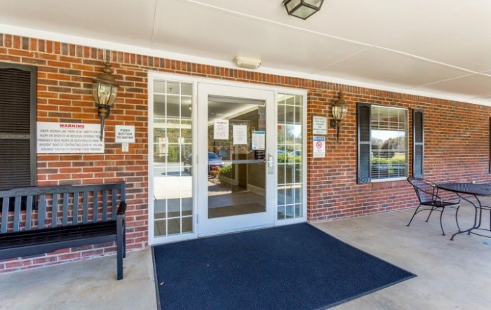 An entrance with glass doors and a brick exterior.