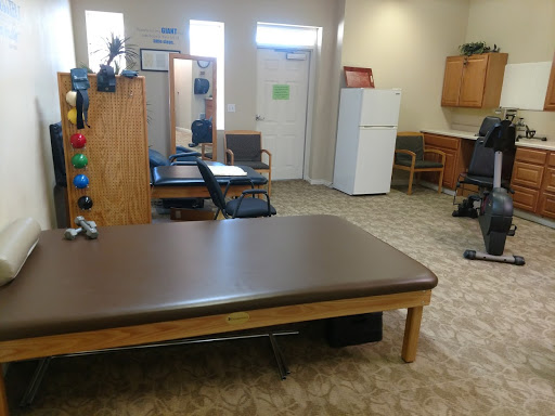 A view of a well-organized therapy room equipped for rehabilitation.
