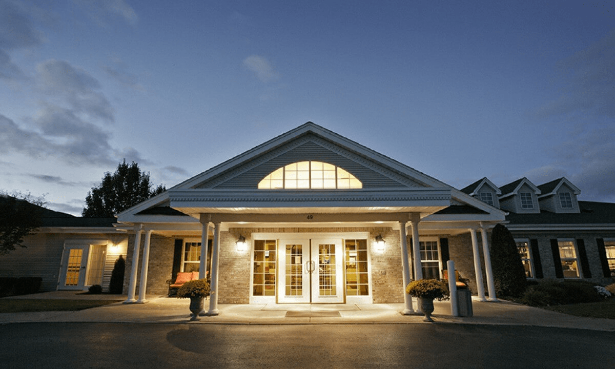An illuminated building entrance during the evening.