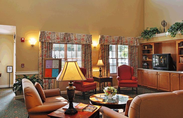 A cozy living room with comfortable seating and warm lighting.