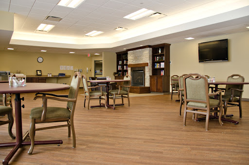 A cozy community lounge featuring comfortable seating, a warm fireplace, and an inviting atmosphere.