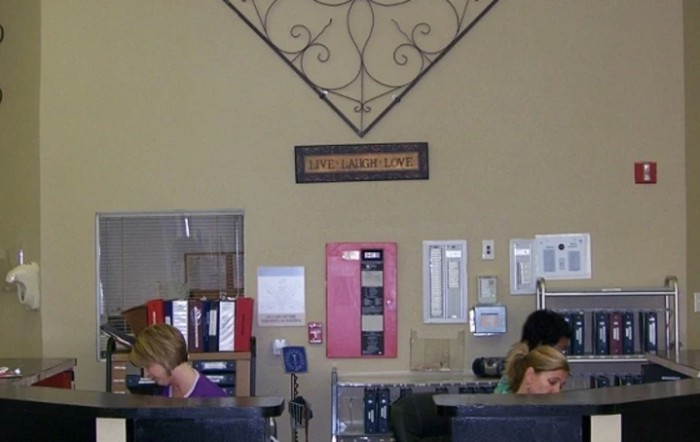 Employees working at desks in an office environment.