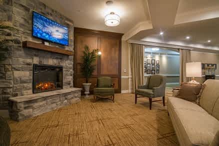 A cozy living room with a fireplace, television, and comfortable seating area.
