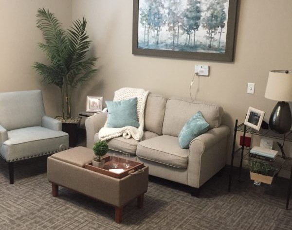 A cozy living room with a sofa, coffee table, and decorative elements.