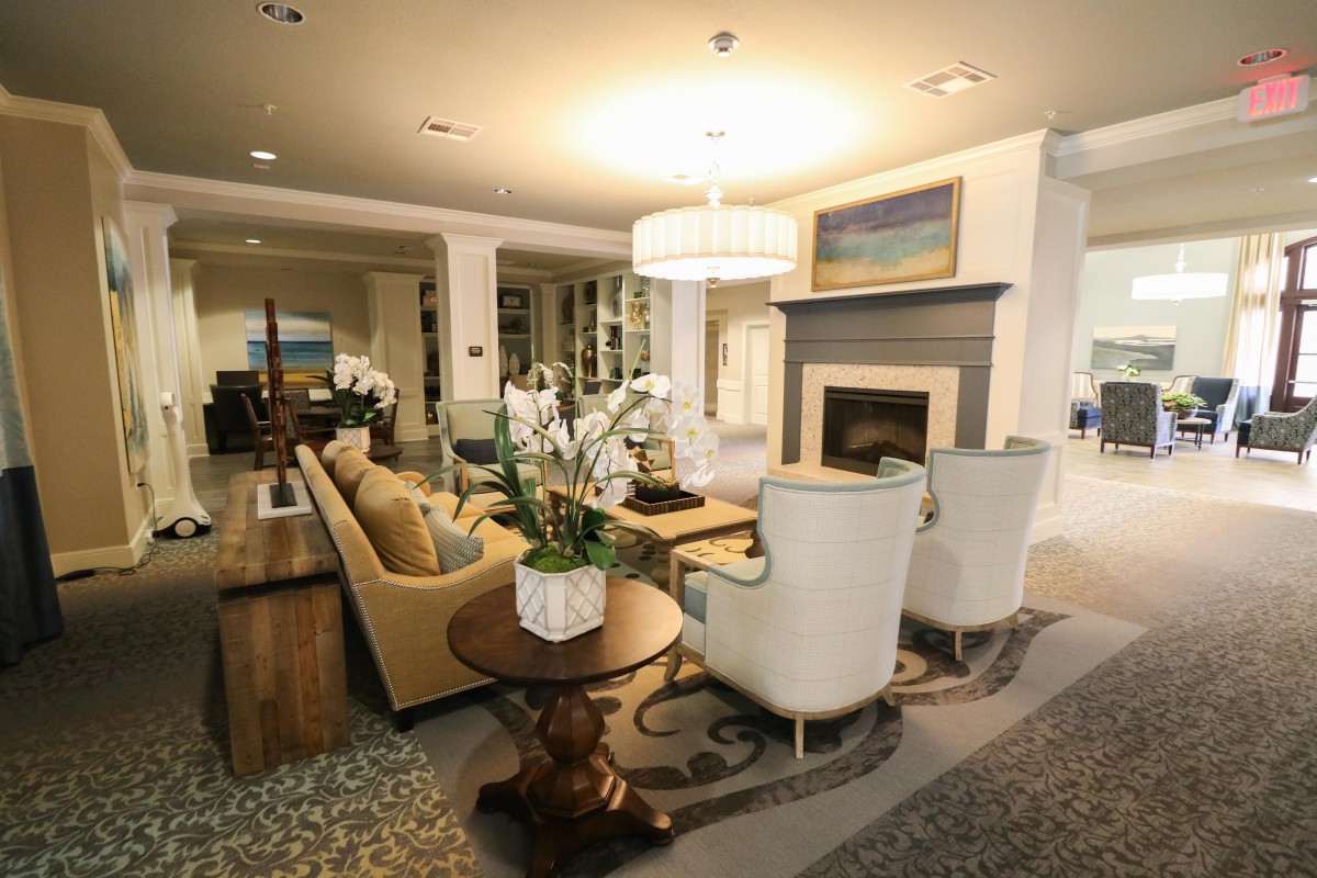 A modern and cozy living room featuring a fireplace, elegant furniture, and tasteful decor.