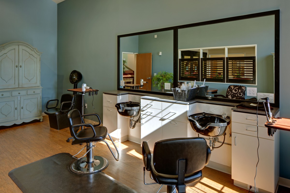 A modern hair salon interior with styling chairs and mirrors.