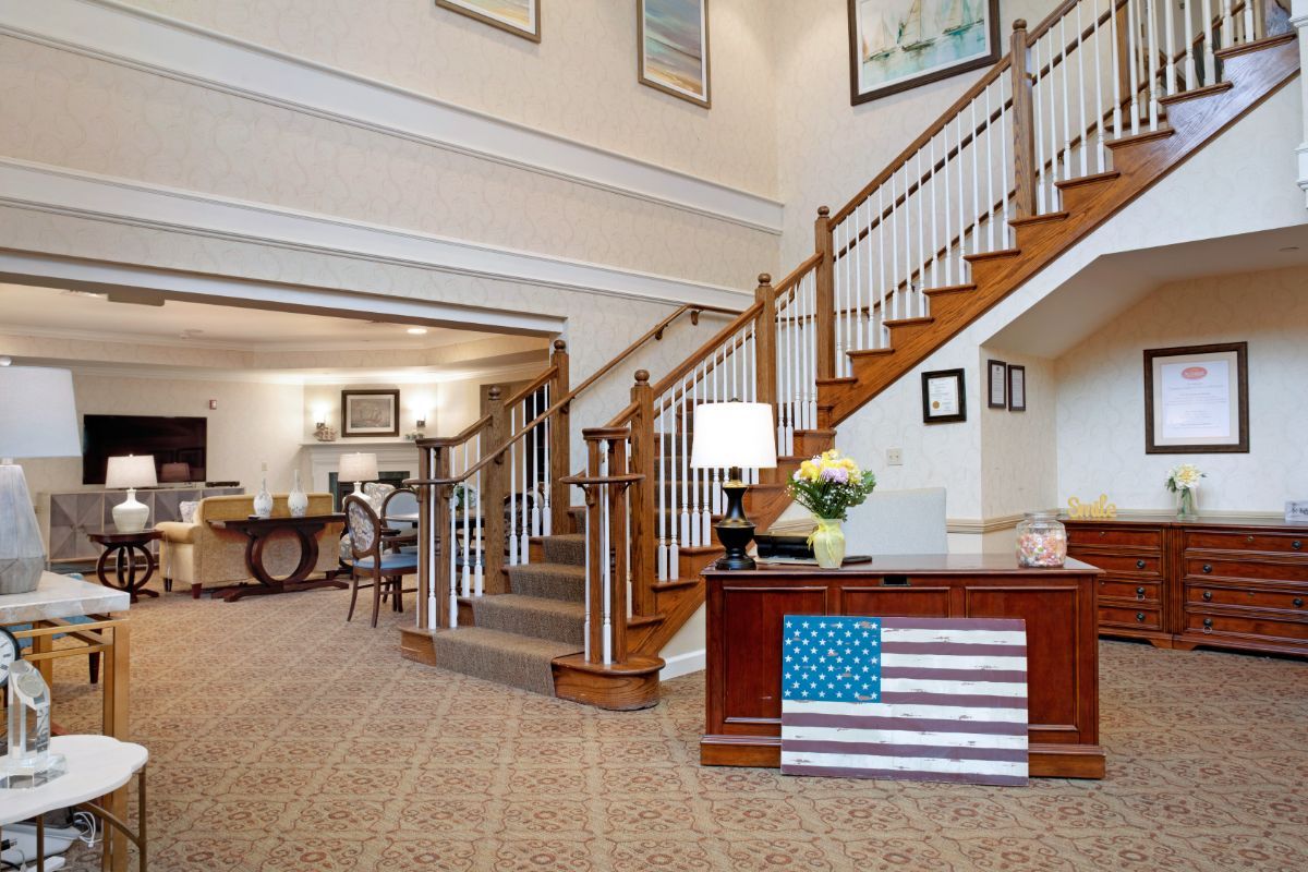 A welcoming lobby area featuring a staircase, reception desk, and tasteful decor.