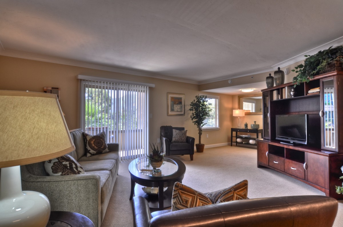 A cozy living room featuring a comfortable seating arrangement, stylish decor, and ample natural light.