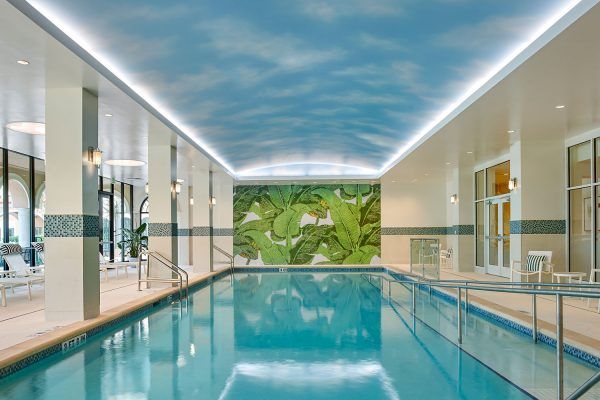A luxurious indoor swimming pool with modern design and ambient lighting, perfect for relaxation and wellness activities.