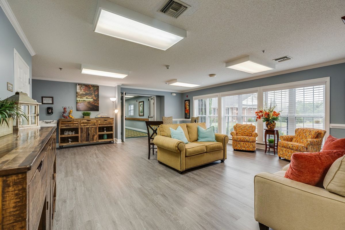 A spacious and well-lit living room with comfortable seating and stylish decor.