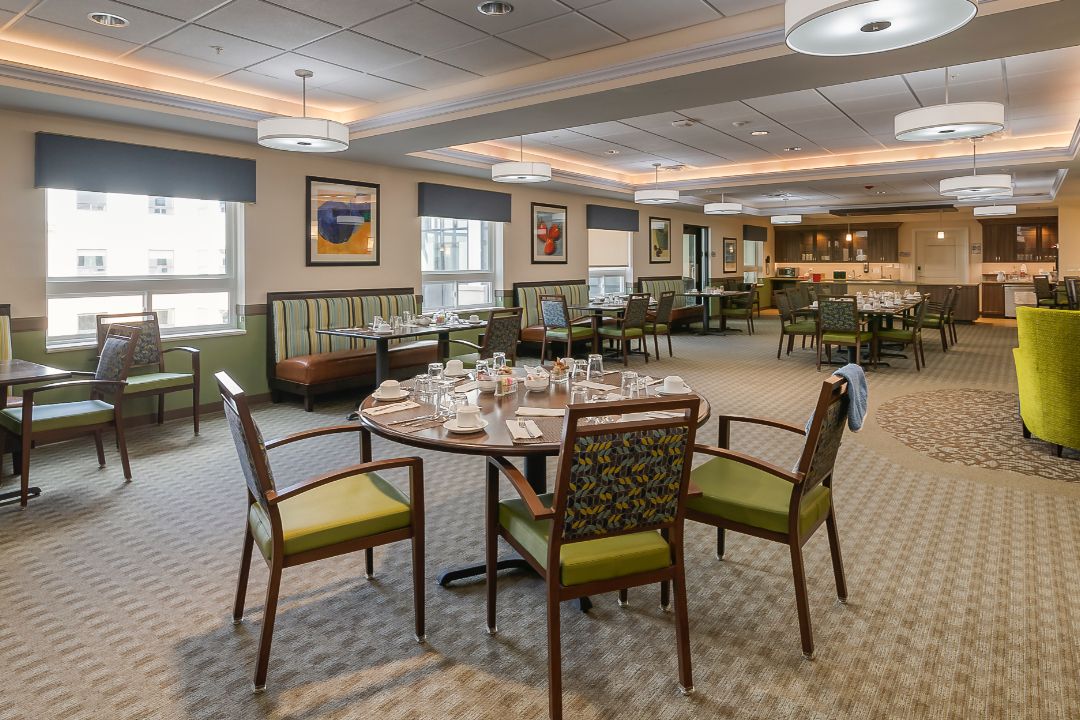 An elegantly set dining area with neatly arranged tables and chairs.