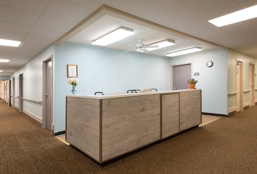 A modern reception desk in a well-lit office environment.