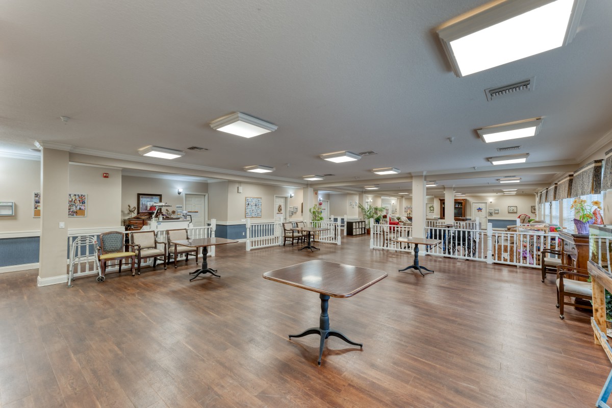 A spacious dining area with wooden floors and ample seating.