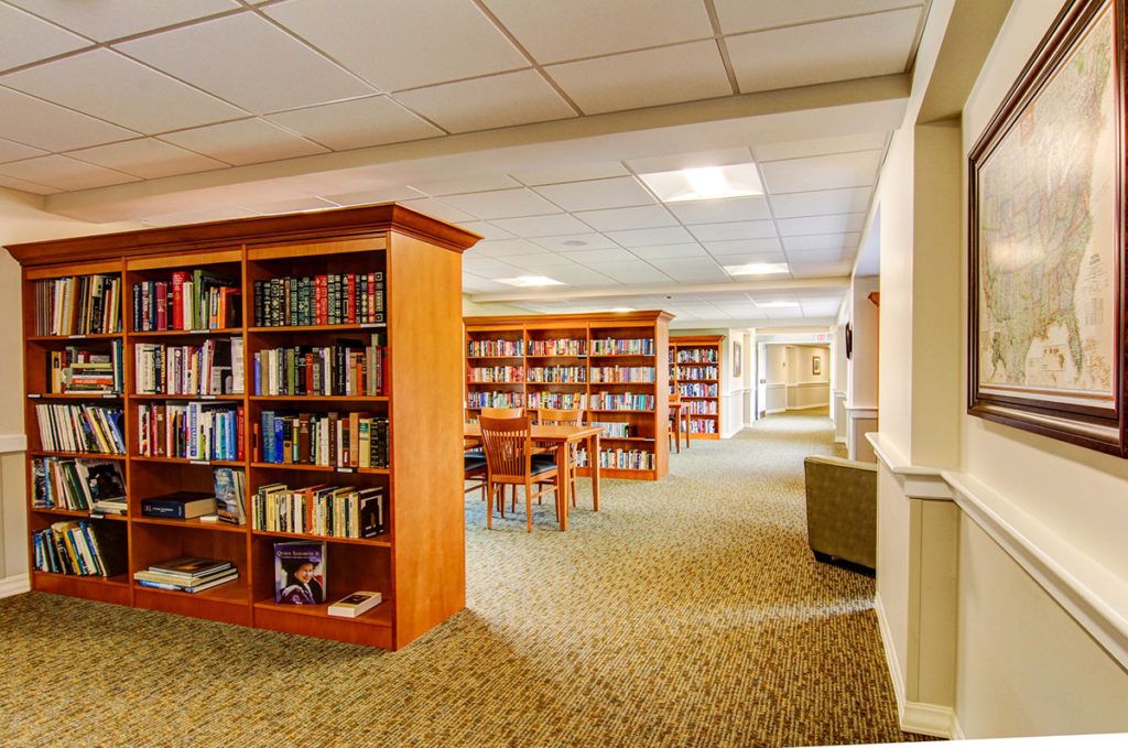 A cozy library interior with bookshelves and a reading area.