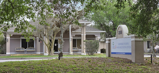 A view of a modern building surrounded by greenery.