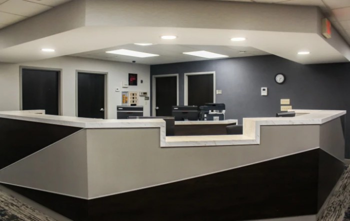 A modern and clean office reception area with a central desk.
