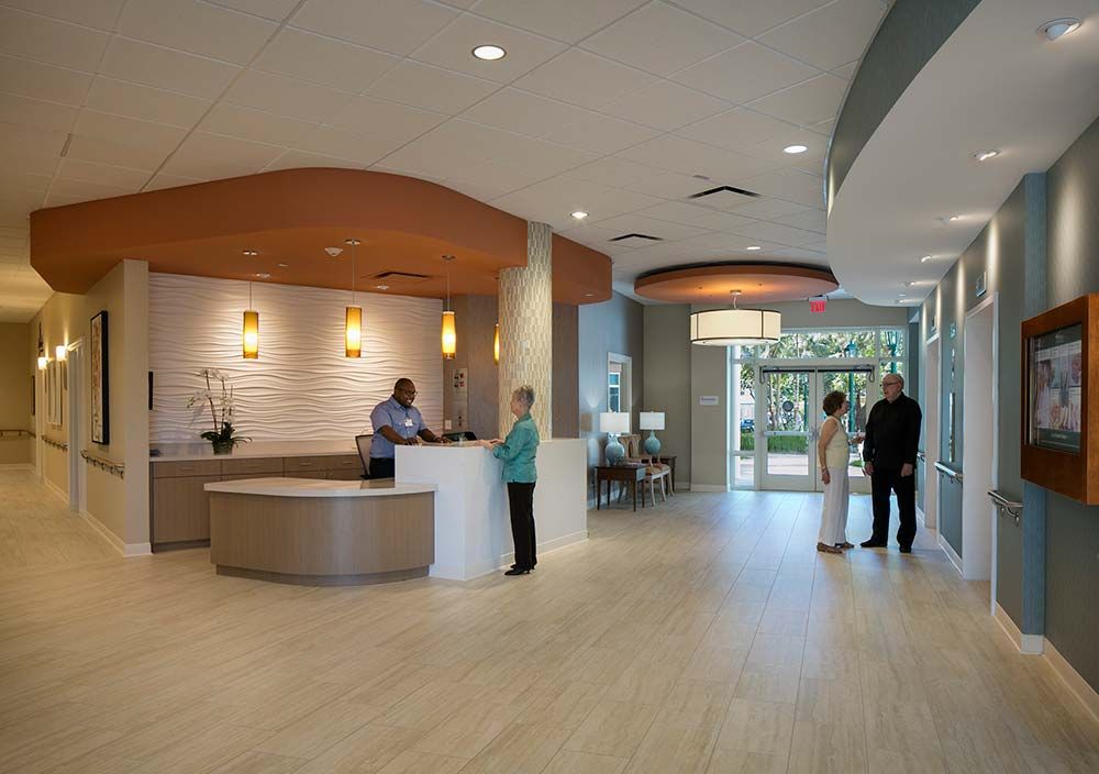 Modern reception area with people interacting in a well-lit lobby.