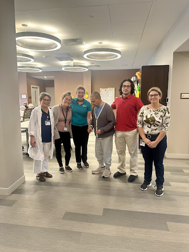 A group of healthcare professionals gathered together in a modern facility, showcasing teamwork and positivity.