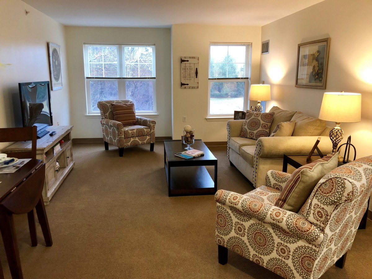 Cozy living room with comfortable seating and warm lighting.