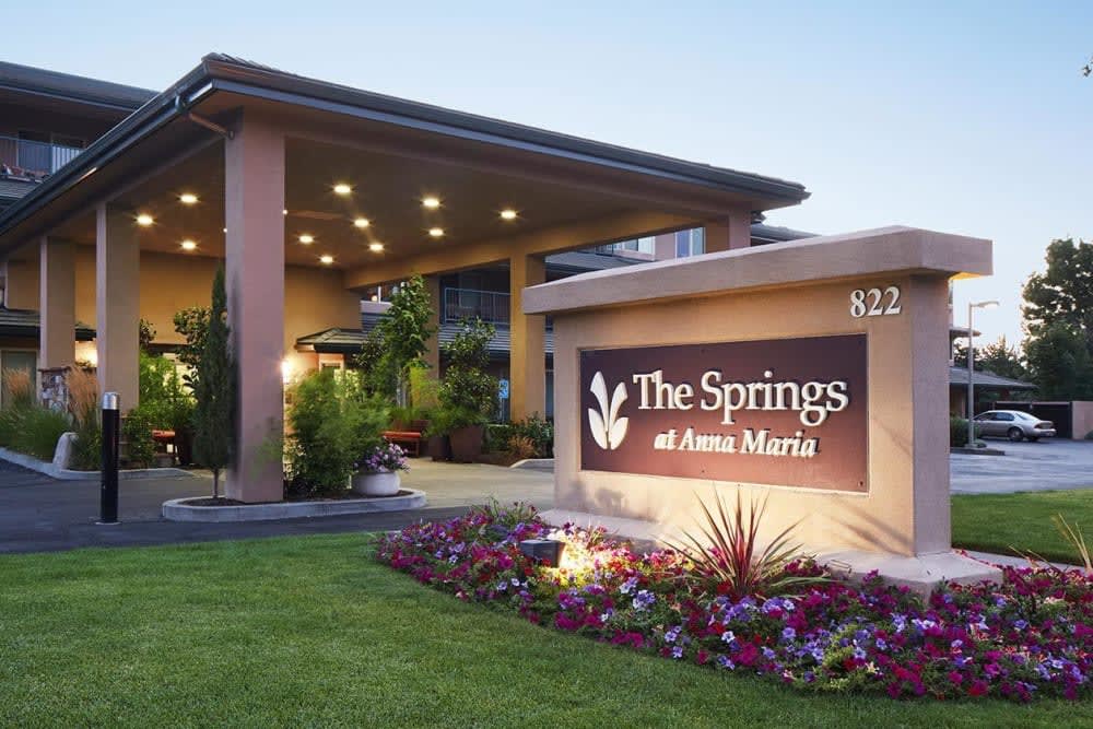 Entrance of The Springs at Anna Maria with illuminated signage and well-maintained landscaping.