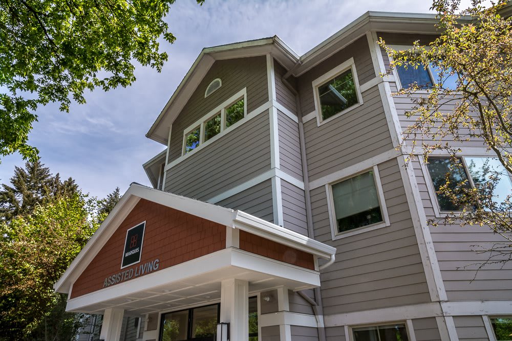 A modern residential building with multiple stories and a contemporary design.