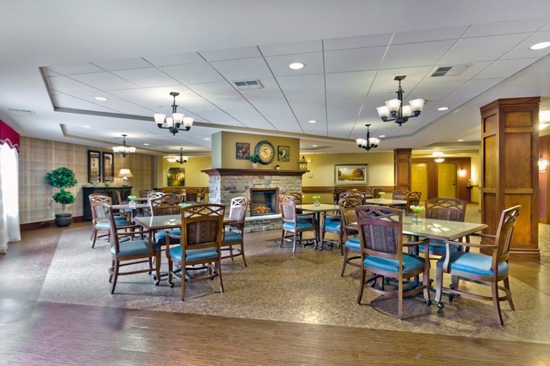 Cozy dining area with elegant furniture and a central fireplace.