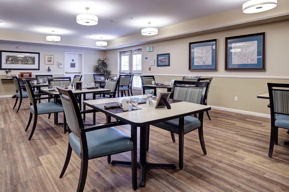 A well-lit dining area with tables and chairs arranged neatly.